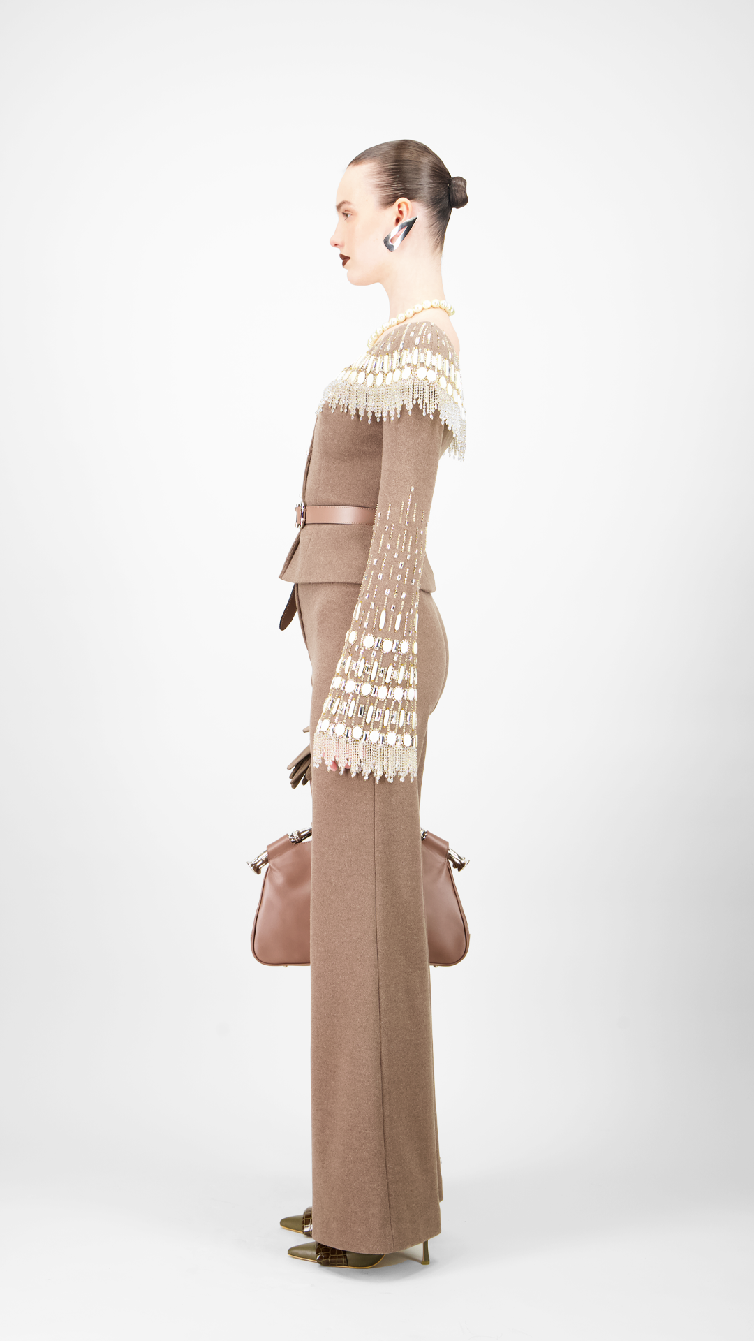 Woman wearing a beaded jacket with belt