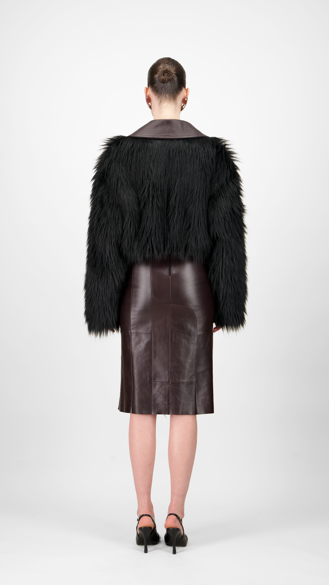 women wearing a black fur coat and leather skirt