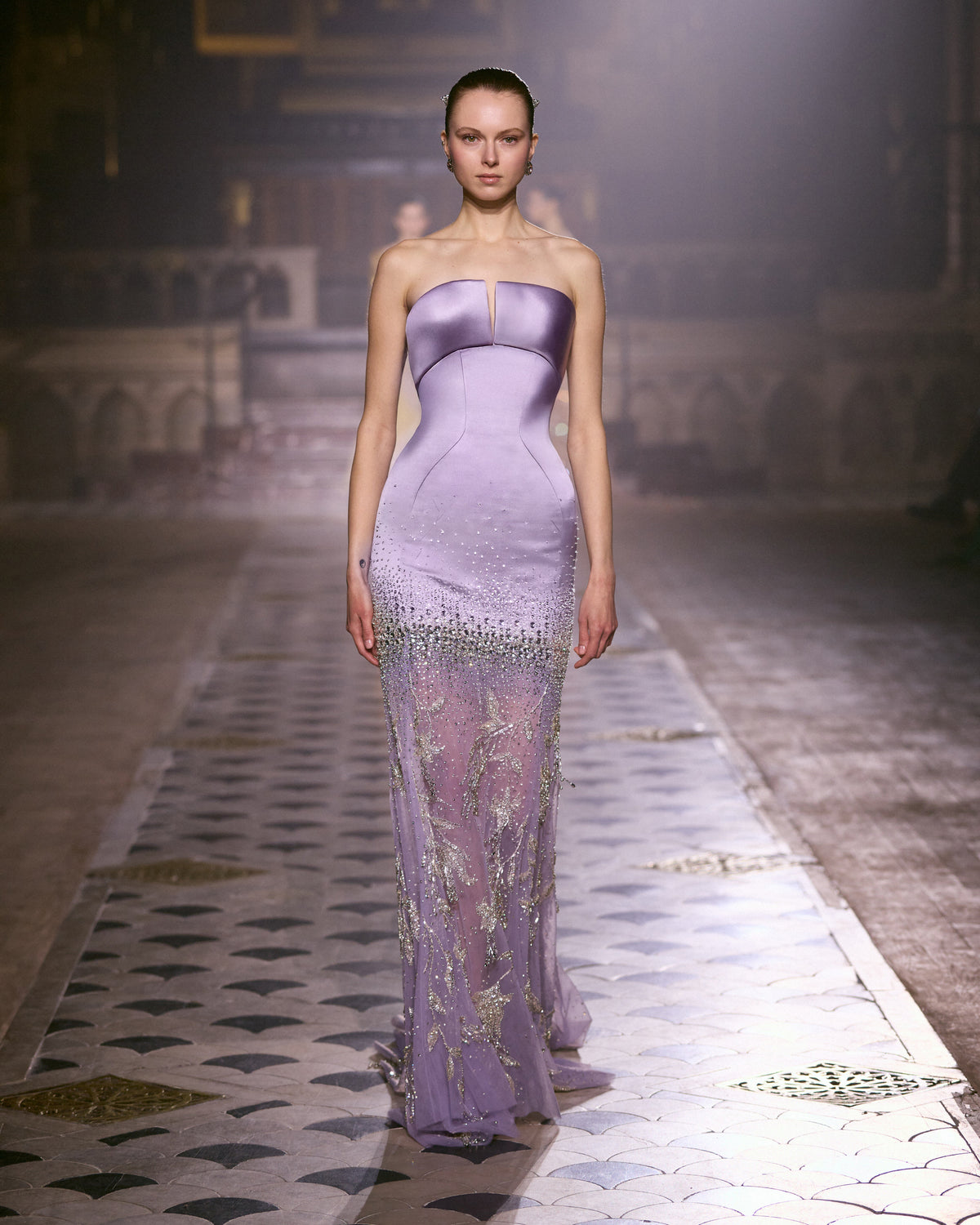 Lilac strapless couture gown with sculpted satin bodice and crystal-embellished sheer skirt.