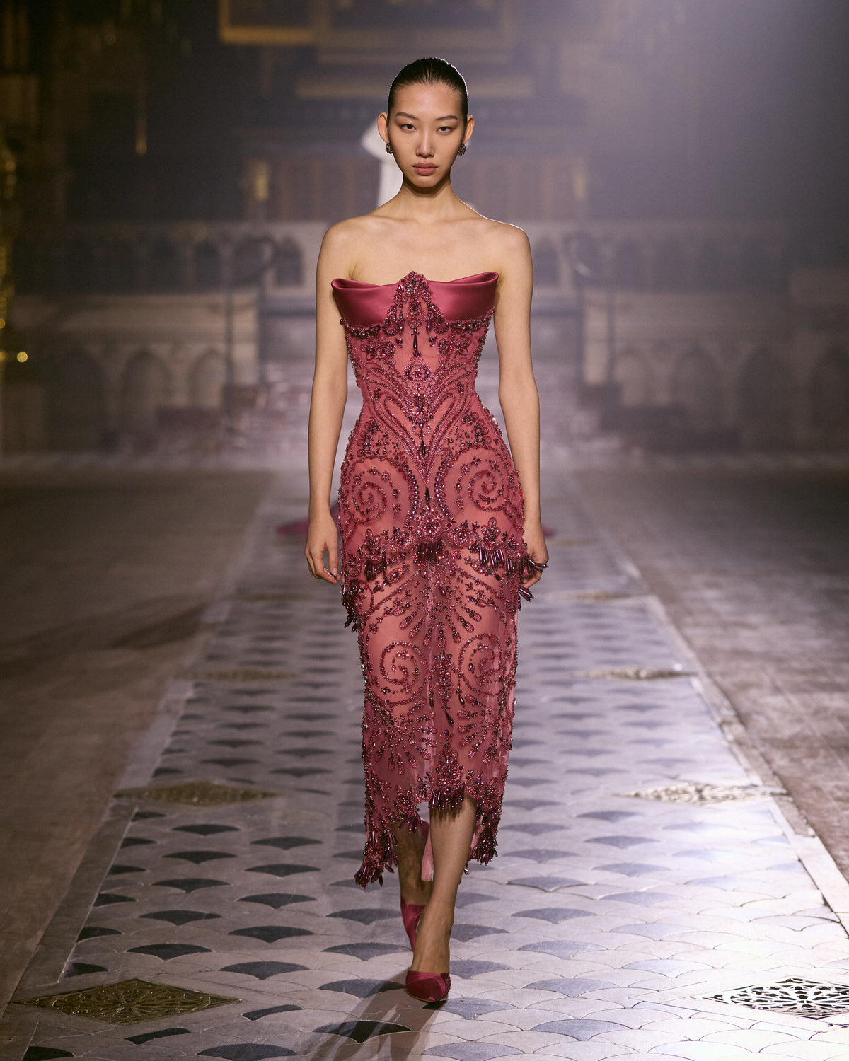 Rose couture midi dress with sculpted satin neckline and intricate crystal embellishments.