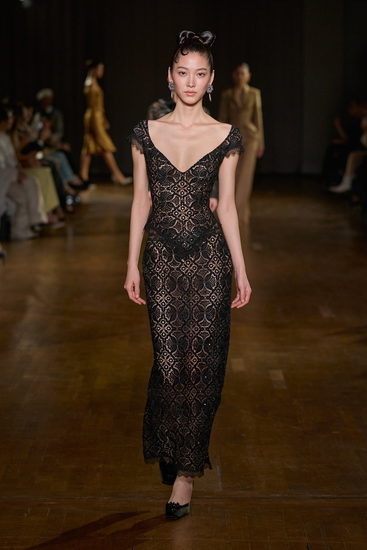Black floral lace top with a deep neckline paired with a matching sheer lace maxi skirt.