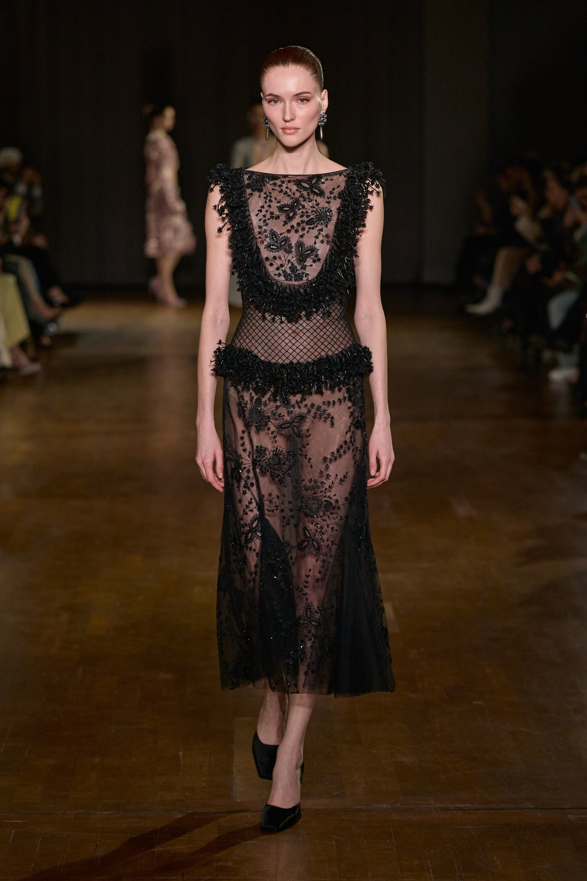 Black sheer tulle midi dress with floral embroidery, beaded detailing and textured trims at the bodice and waist.
