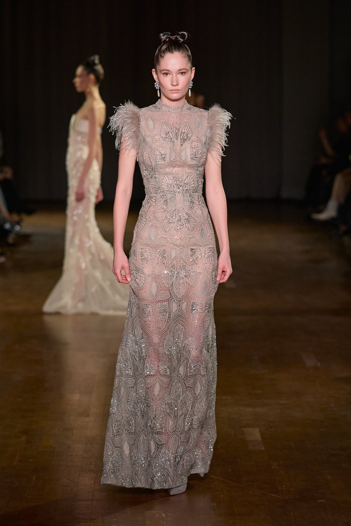 Taupe floor-length embroidered gown with high neckline, fitted silhouette and feather-trimmed shoulders.