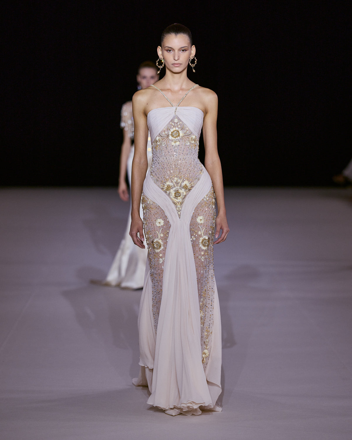 Blush draped gown with sheer panels, delicate straps, gold floral embroidery and crystal embellishments.