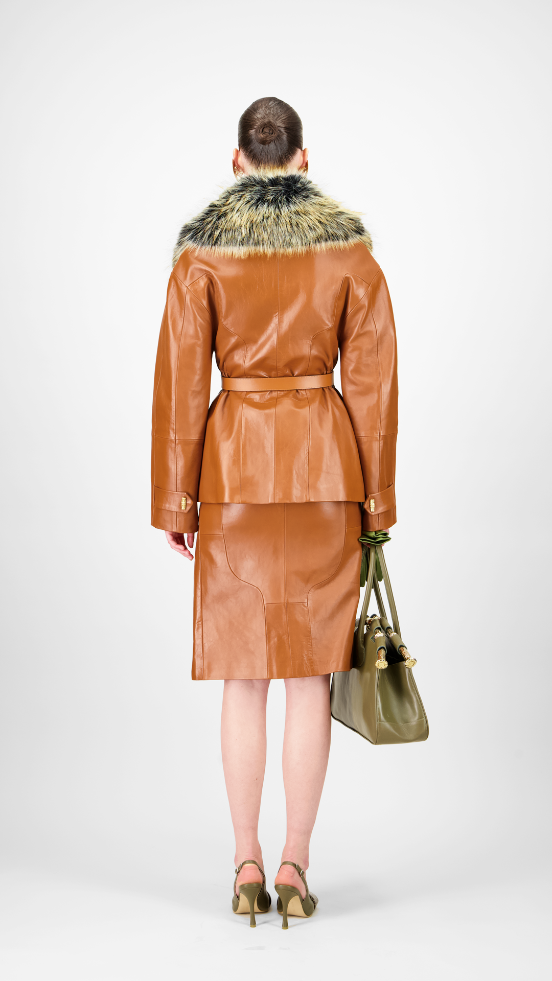 Woman wearing a brown leather coat with fur trim 