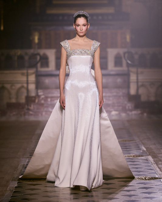 Bride walks the runway in Georges Hobeika Couture Spring–Summer 2026 Look 45, wearing a white bridal evening gown adorned with silver embellishments.