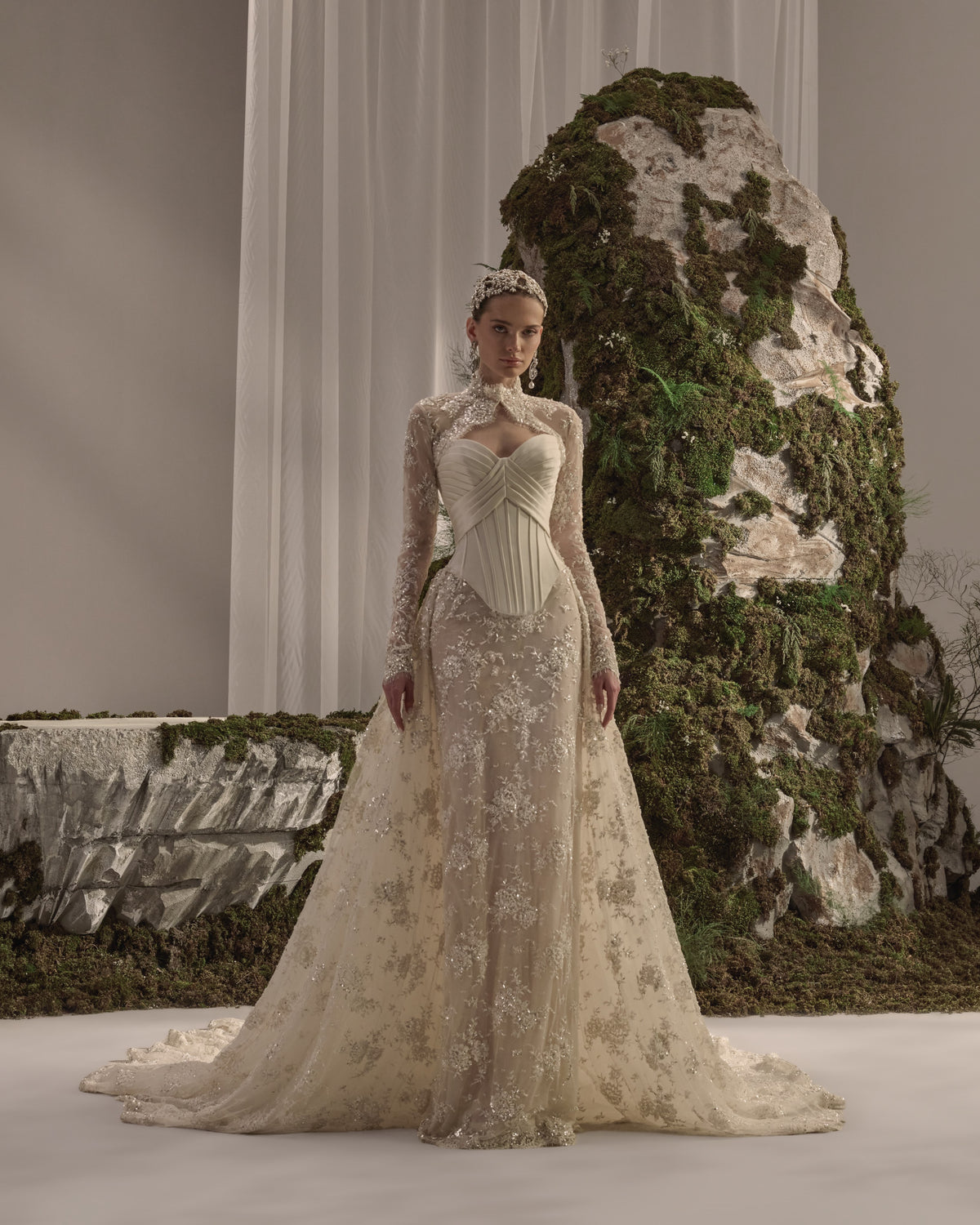 Embellished bridal gown with a structured corset bodice, flowing skirt and detachable long-sleeve embroidered bolero.