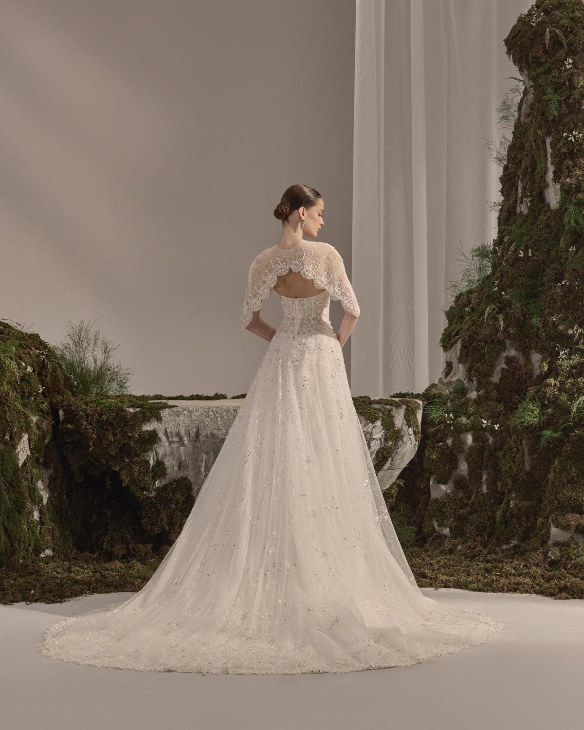 Embellished fitted bridal gown with a detachable sheer embroidered bolero.
