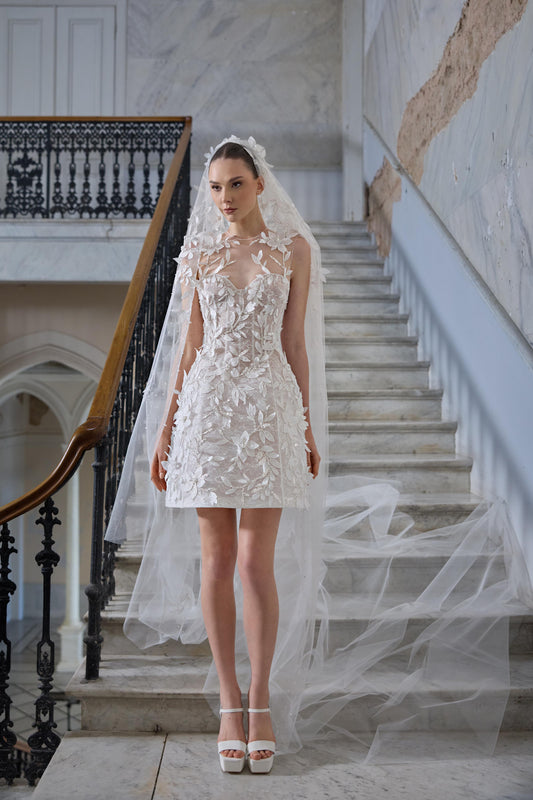 Mini bridal dress with a sheer neckline, three-dimensional floral appliqués, leaf embroidery and a long sheer tulle veil.