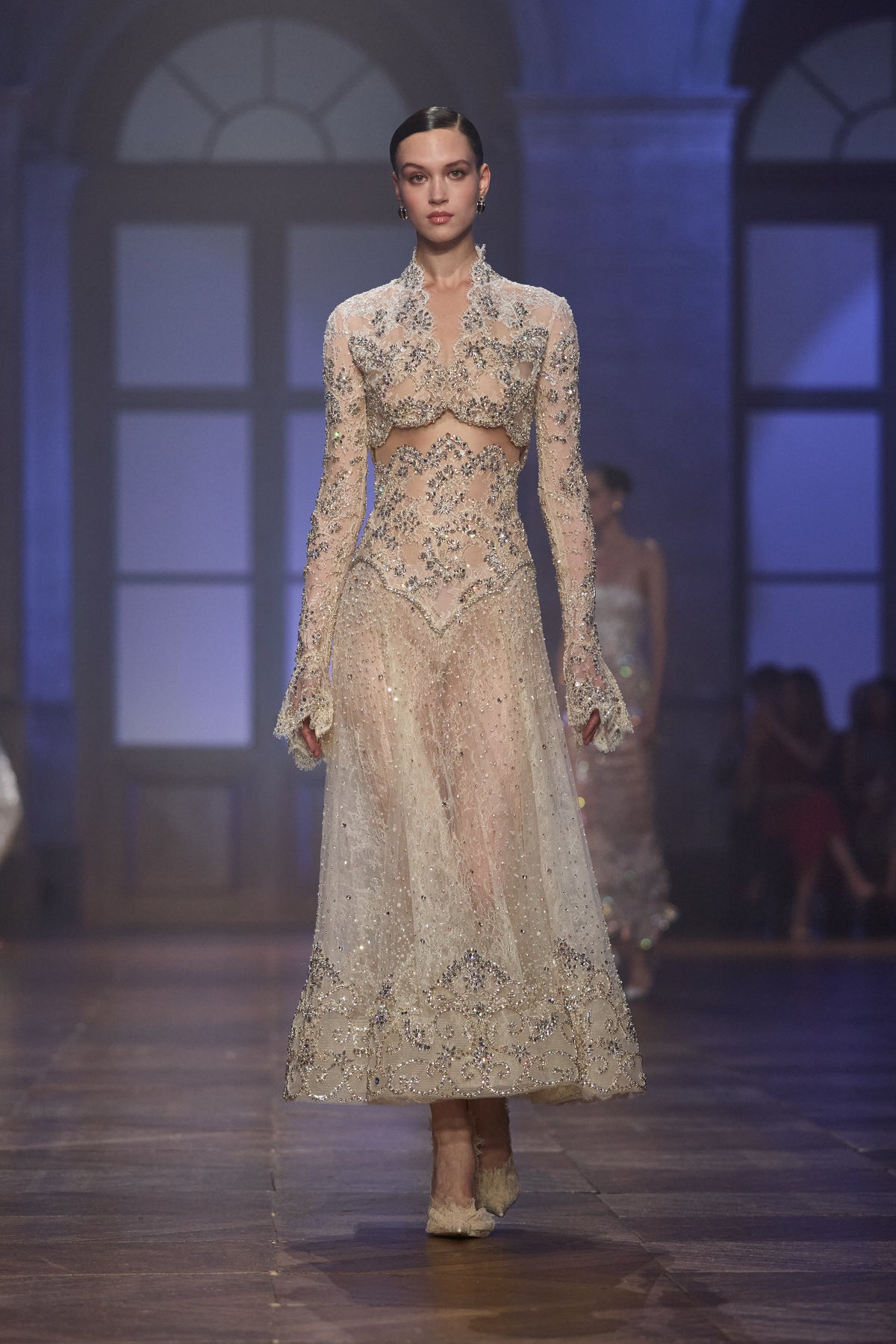 Ivory couture look featuring a long-sleeve embellished lace bolero and sheer midi dress with intricate crystal embroidery.