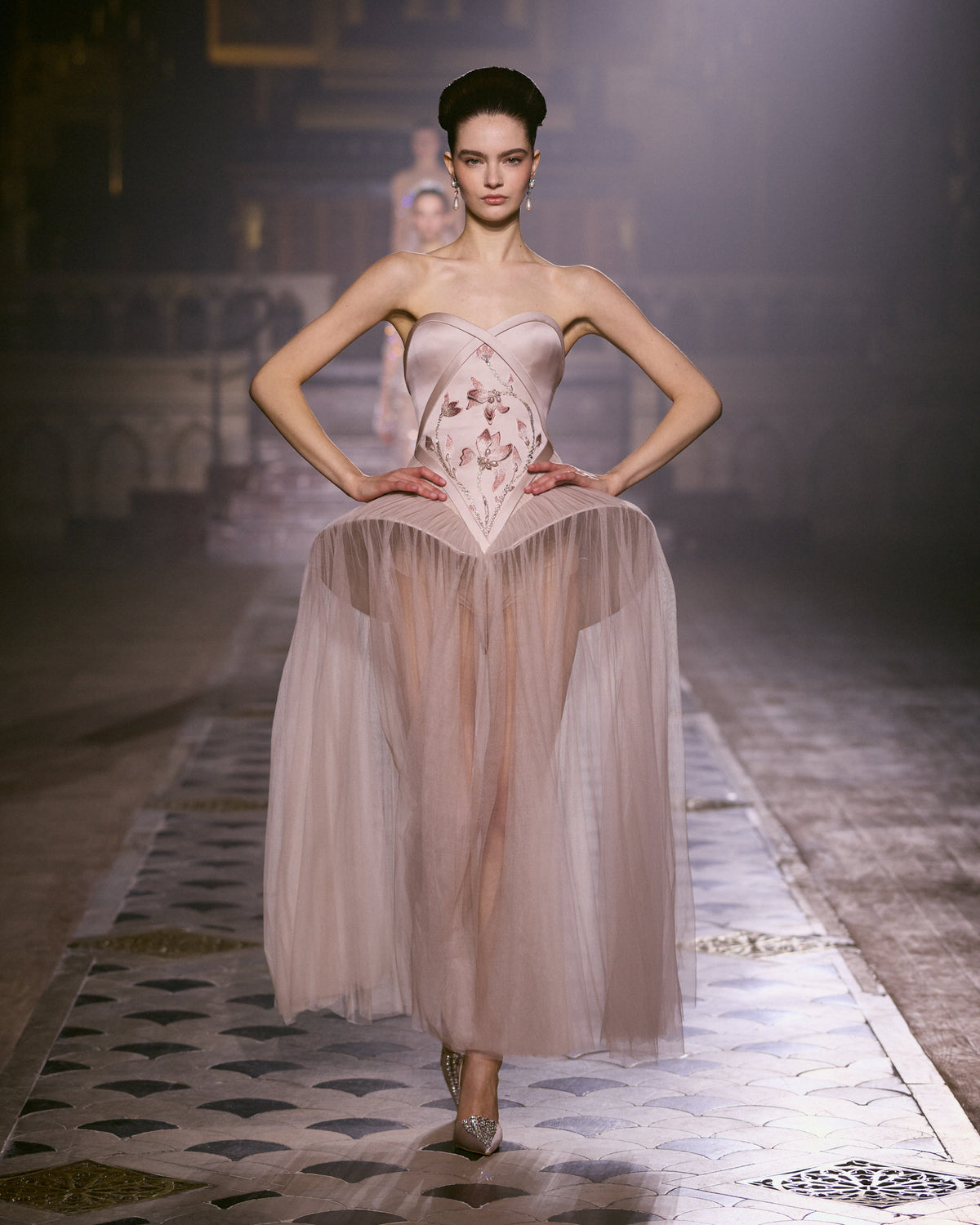 Blush pink strapless couture dress with floral embroidered bodice and sheer flowing tulle skirt.