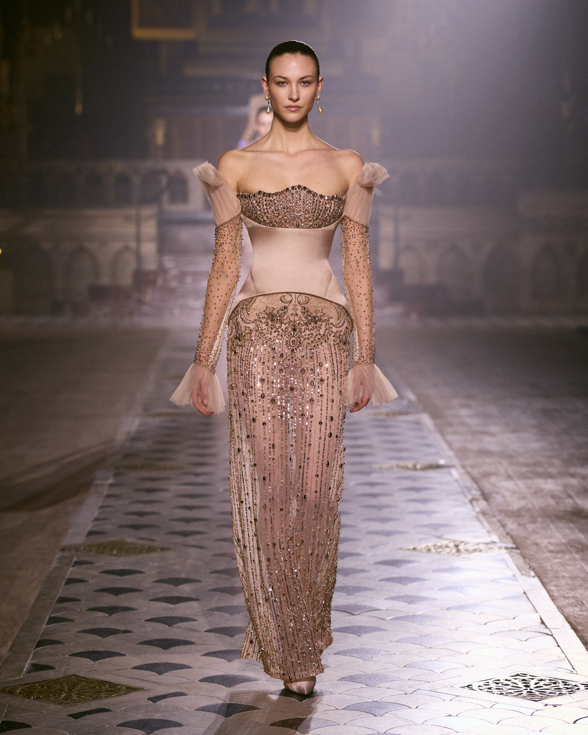 Blush pink couture gown with sculpted bodice, embellished sheer sleeves and intricately beaded skirt.