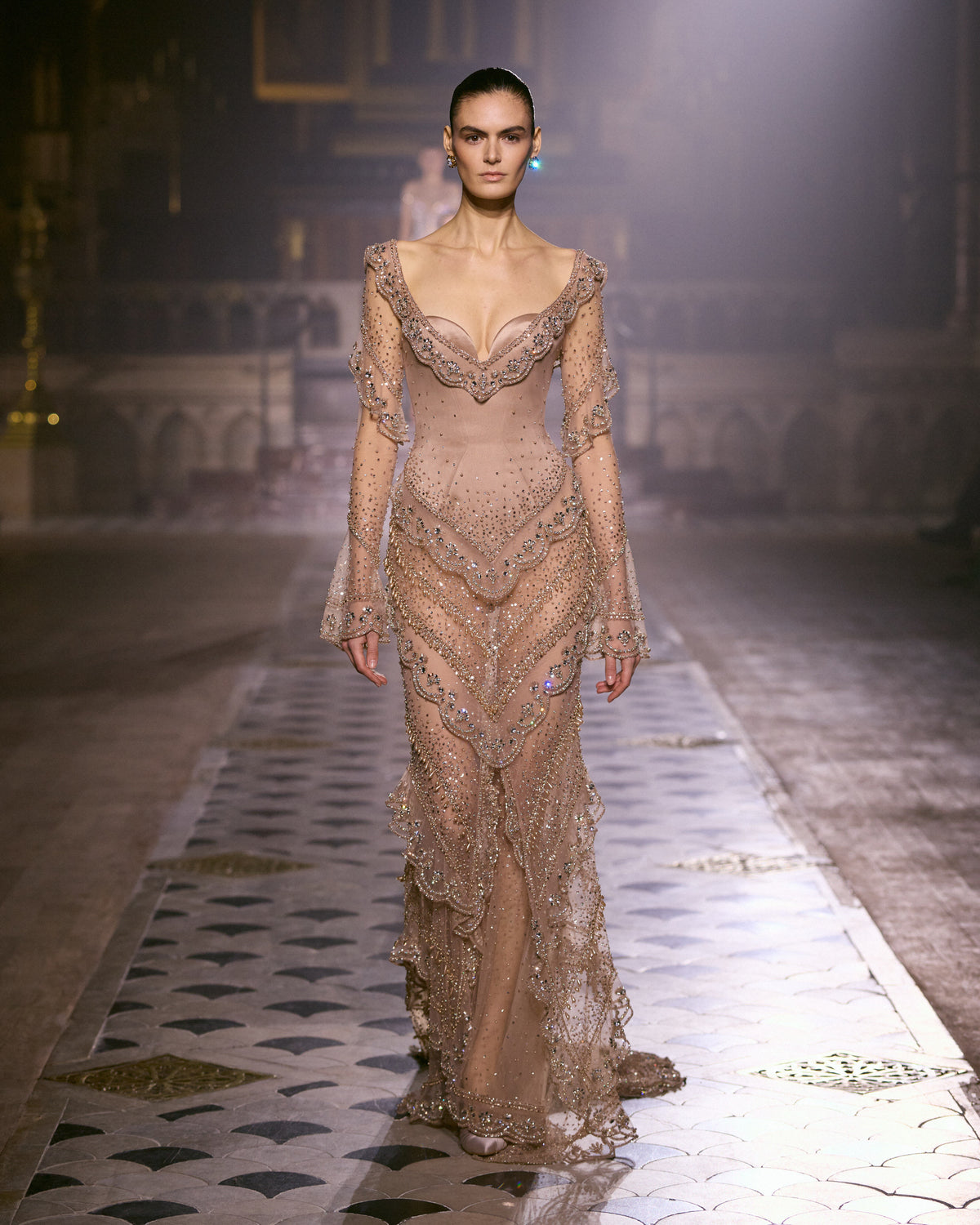 Blush pink sheer couture gown with long sleeves, sculpted detailing and intricate crystal embellishments.