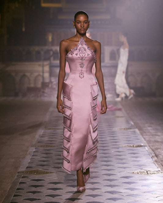 Blush pink halter couture gown with crystal embellishments and structured column skirt.
