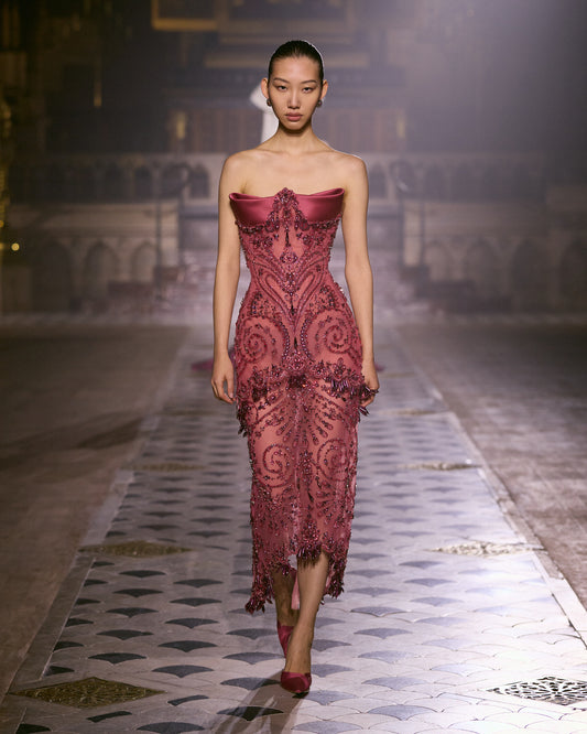 Rose couture midi dress with sculpted satin neckline and intricate crystal embellishments.