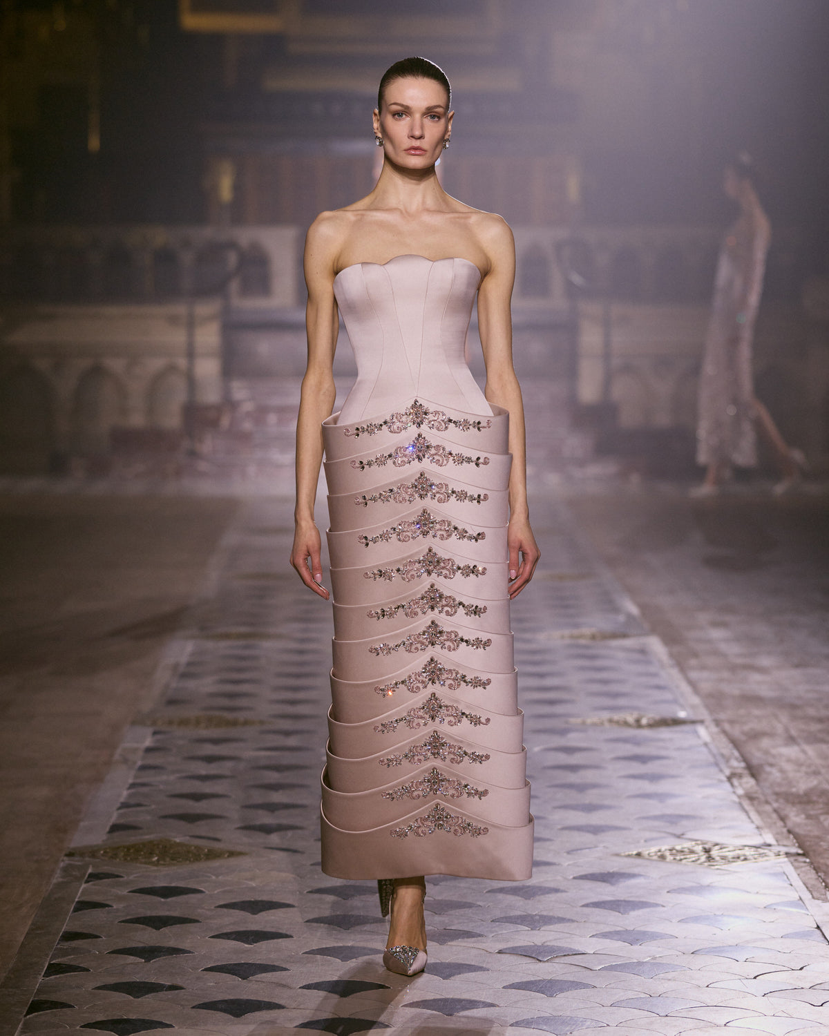 Blush pink strapless couture dress with a sculpted silhouette and intricate crystal embroidery.