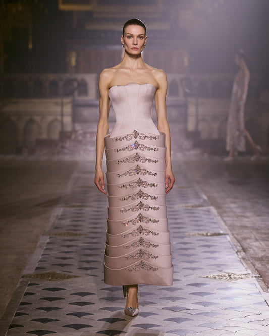 Blush pink strapless couture dress with a sculpted silhouette and intricate crystal embroidery.