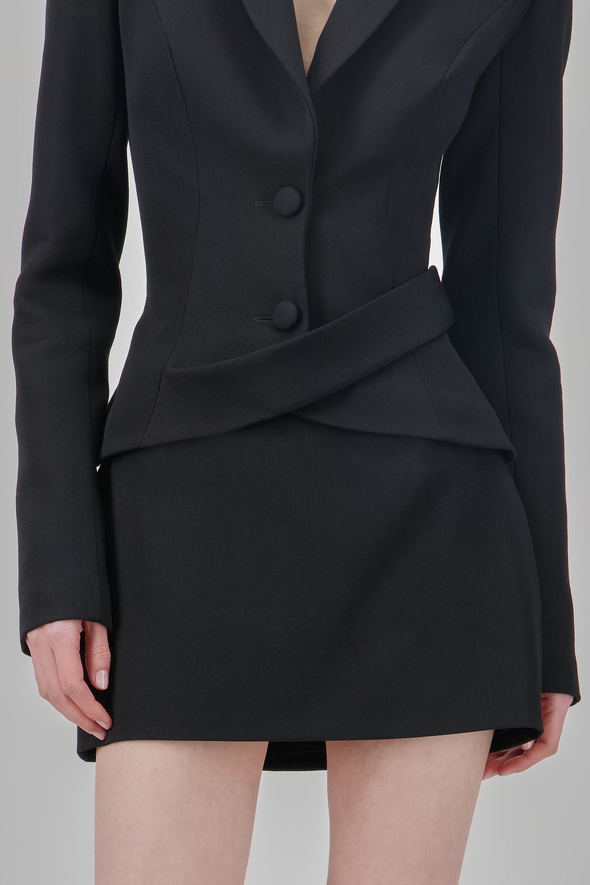 Black wool mini skirt with a clean tailored silhouette, structured finish and minimalist design.