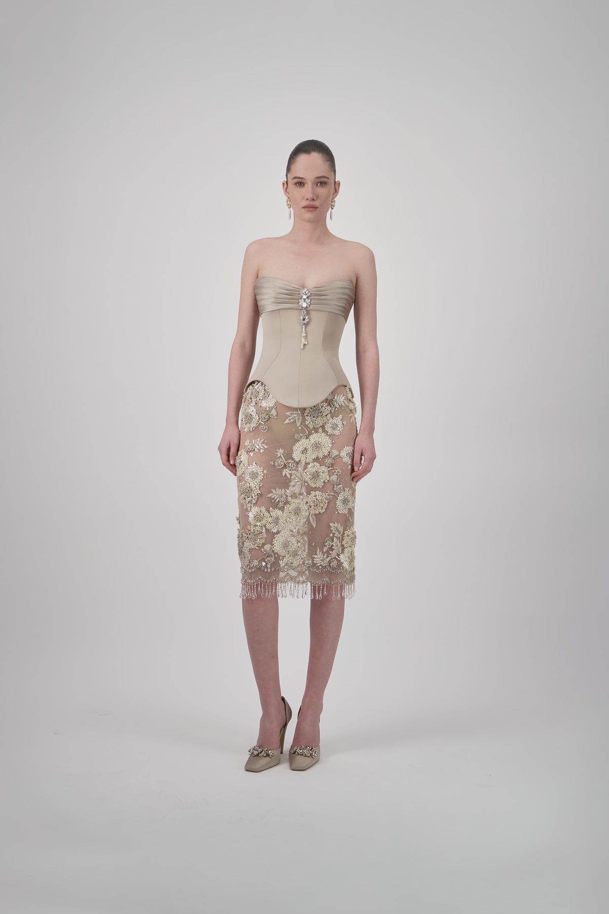 Rye beige tulle short skirt with intricate floral embroidery, delicate beadwork, sheer detailing and beaded fringe.