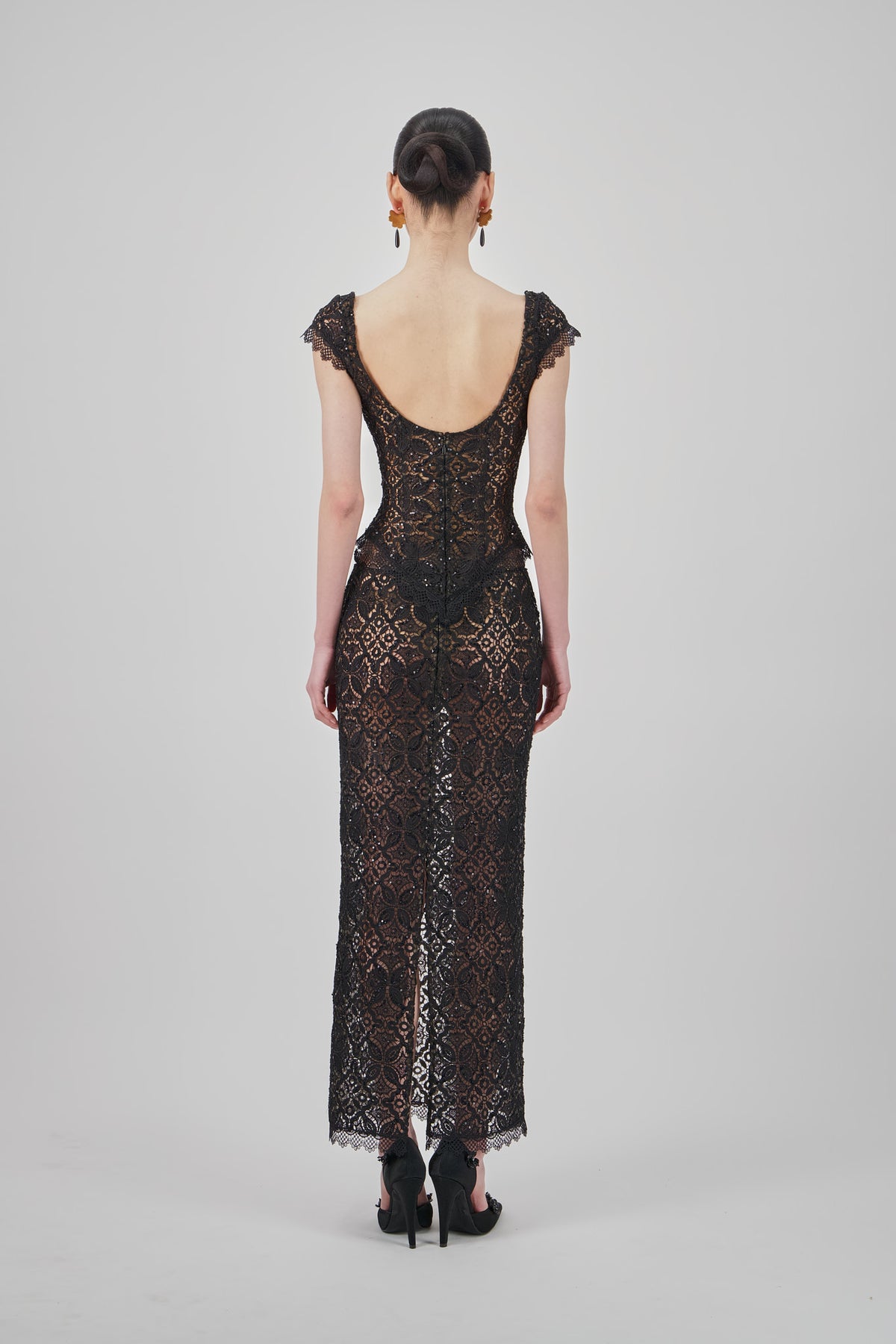 Black lace midi skirt with a straight silhouette, intricate floral lace pattern and delicate scalloped hem.
Black lace V-neck top with a fitted silhouette, intricate floral lace pattern and delicate cap sleeves.