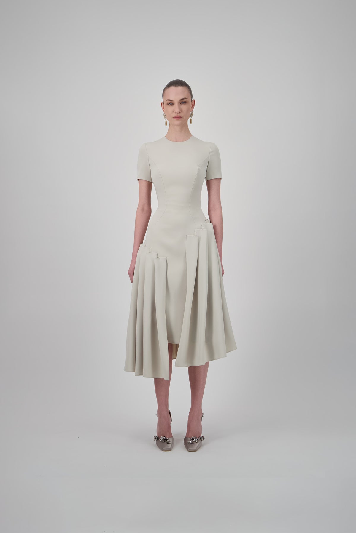 Crepe midi dress with short sleeves, a fitted silhouette and asymmetrical pleated panels along the skirt.
