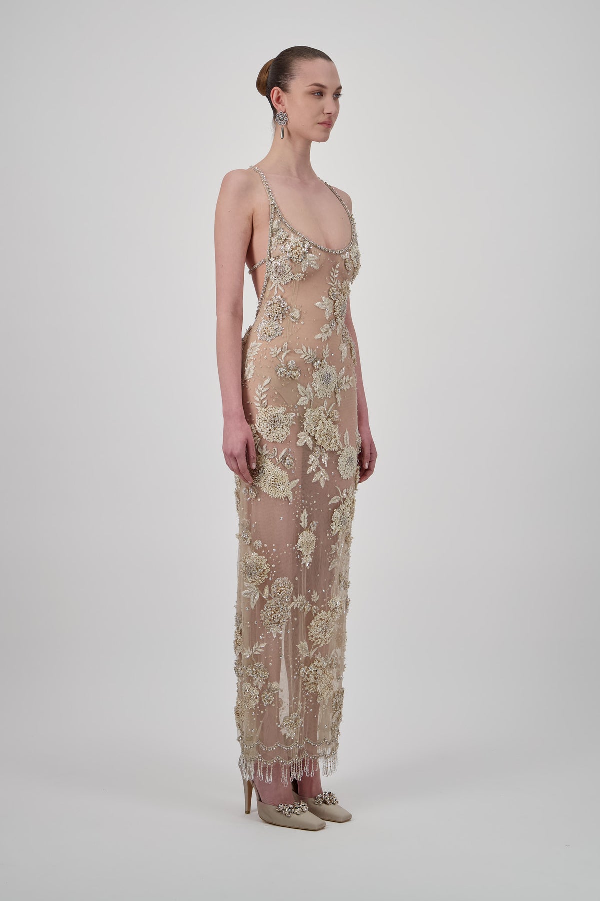 Sheer tulle long dress with intricate floral embroidery, all-over beadwork, scoop neckline and delicate beaded fringe.