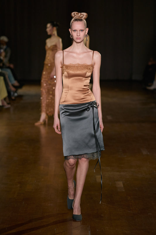 Bronze lace-trimmed satin corset top paired with a grey satin wrap midi skirt featuring lace trim and tie detailing.