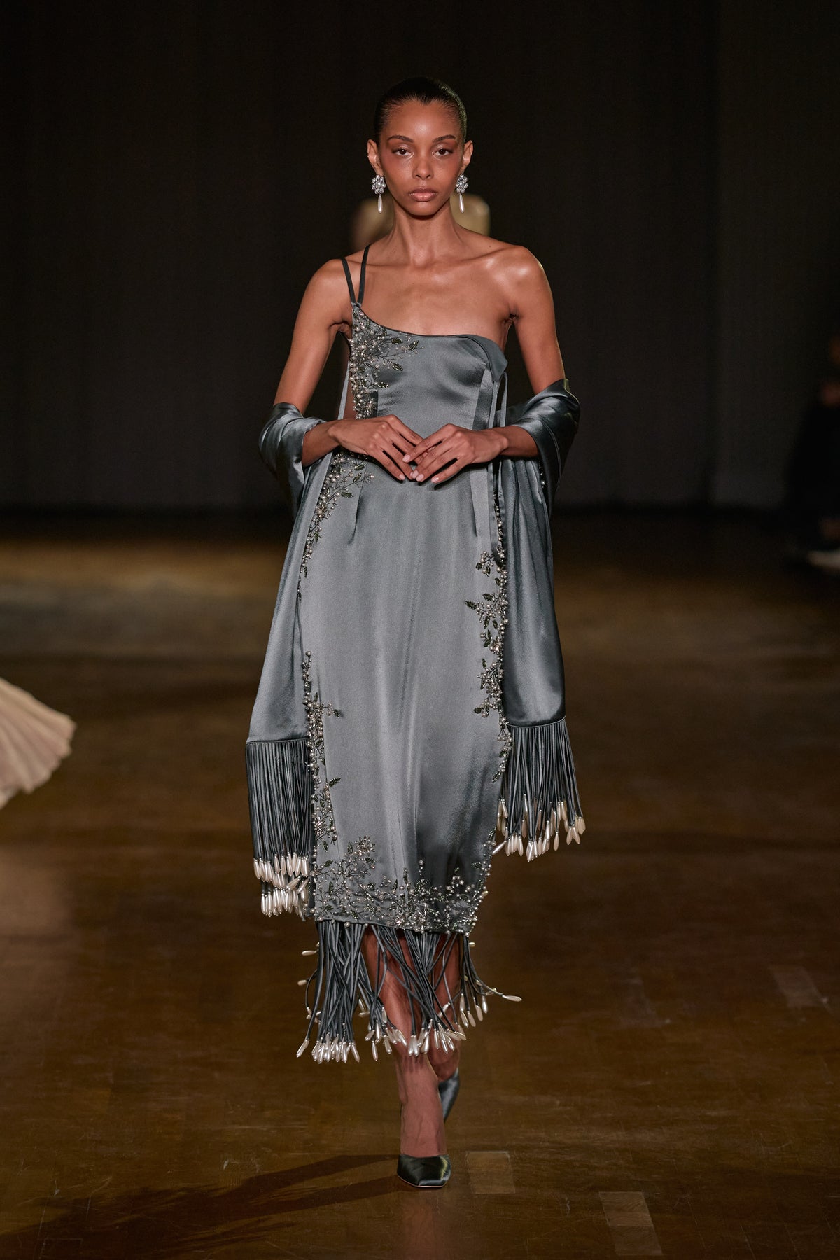 Grey satin midi dress with floral crystal embellishments paired with a matching fringed scarf featuring pearl-drop details.