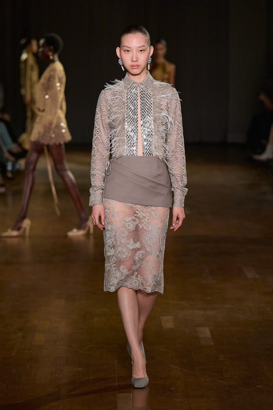 Grey lace shirt with crystal embellishments and feather detailing paired with a layered sheer floral lace midi skirt.
