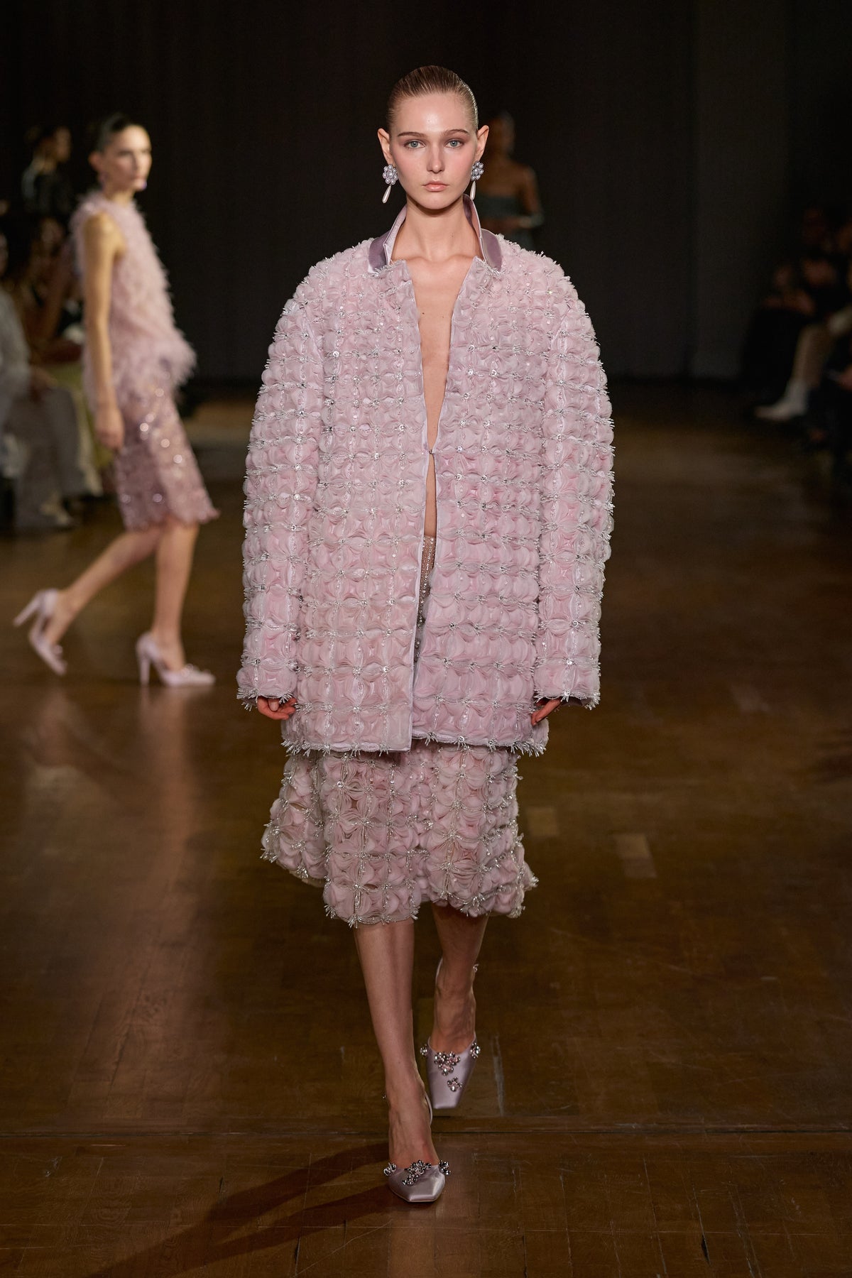 Pink oversized textured jacket paired with a matching embellished midi skirt.