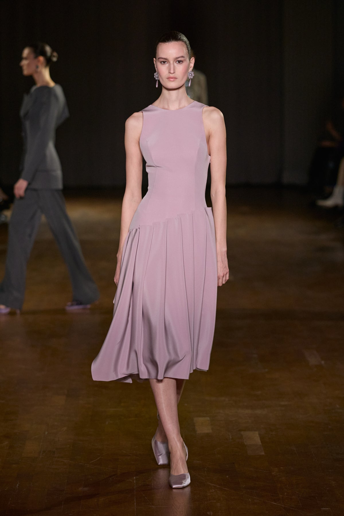 Lilac sleeveless midi dress with a fitted sculpted bodice and softly draped pleated skirt.