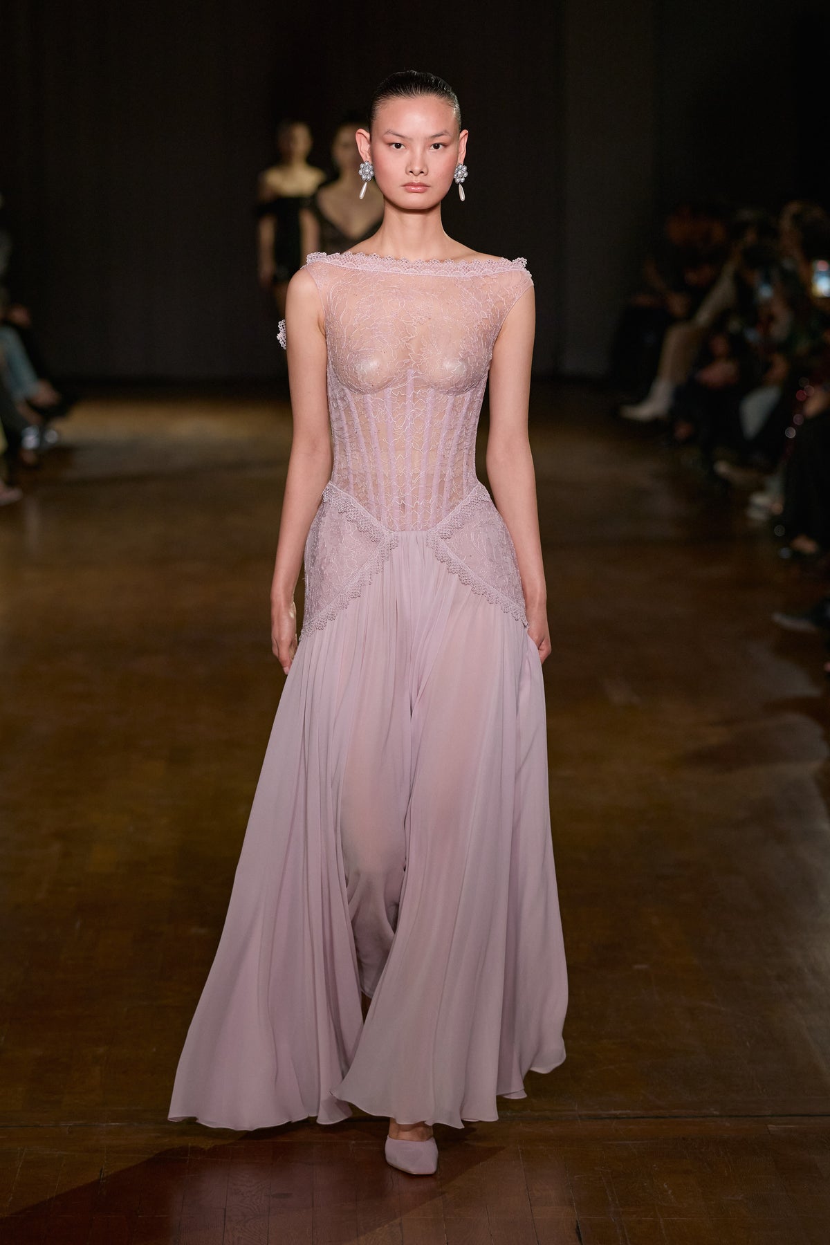 Lilac maxi dress with a sheer lace corset bodice, boat neckline and flowing floor-length skirt.