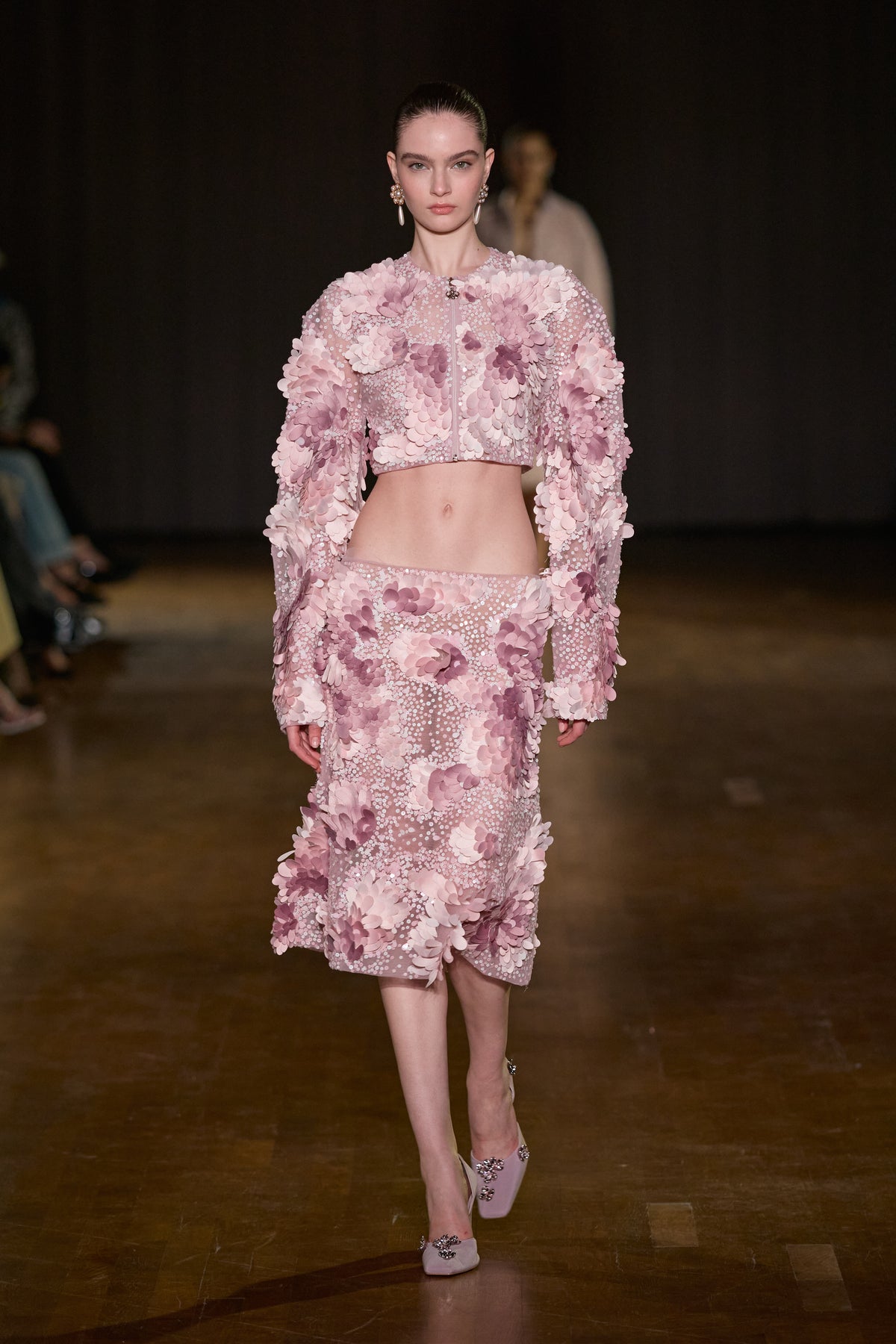 Pink cropped jacket and midi skirt set with dimensional floral appliqués and intricate embellishments.