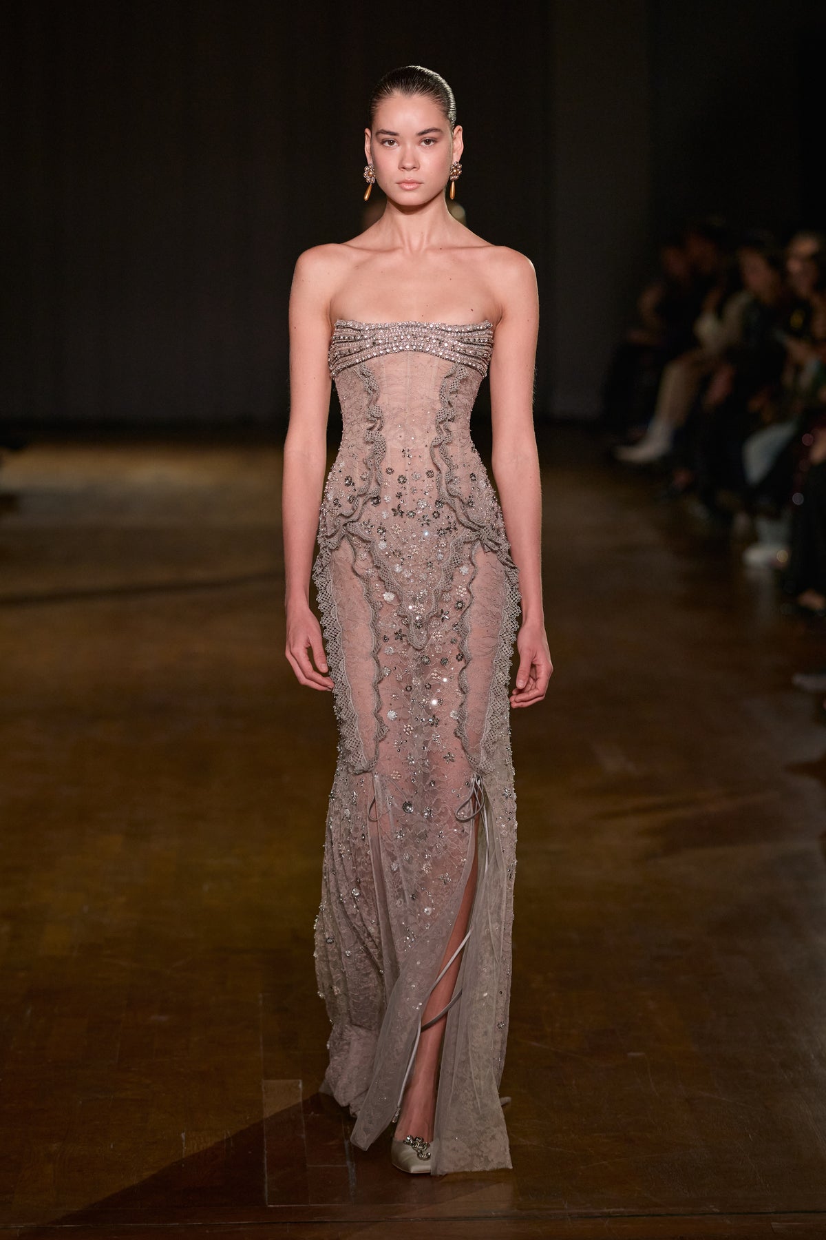 Taupe strapless lace gown with crystal embellishments, sculpted lace detailing and a front slit.