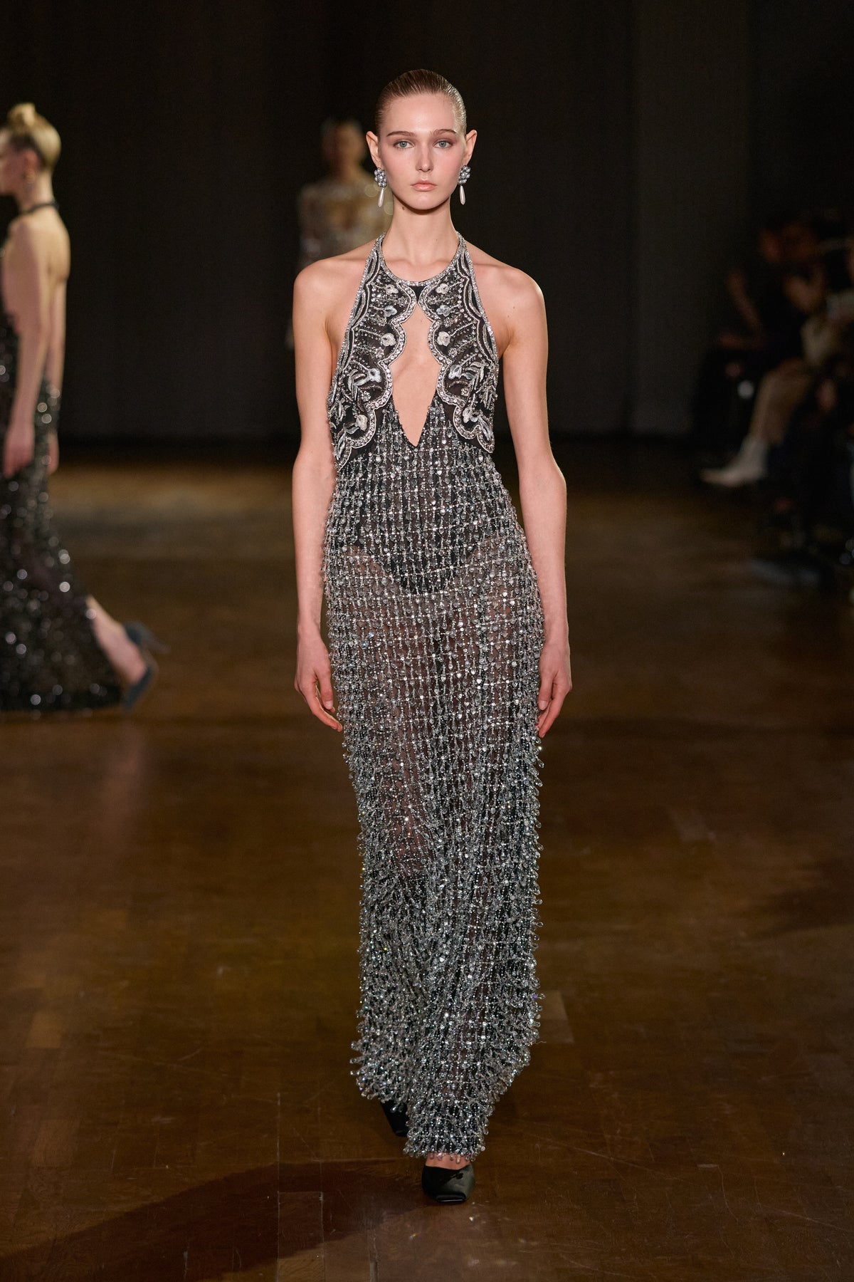 Black and silver halter gown with plunging cutout neckline and cascading crystal embellishments.