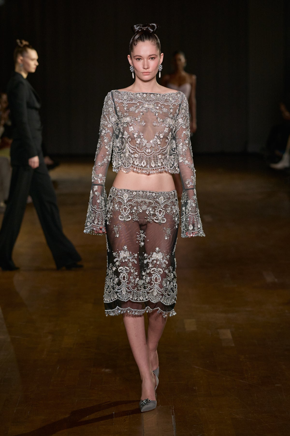 Sheer tulle long-sleeve top and matching midi skirt with intricate crystal embroidery, ornate beading, and scalloped detailing.