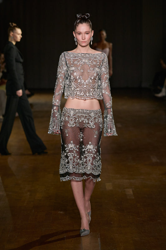 Sheer tulle long-sleeve top and matching midi skirt with intricate crystal embroidery, ornate beading, and scalloped detailing.