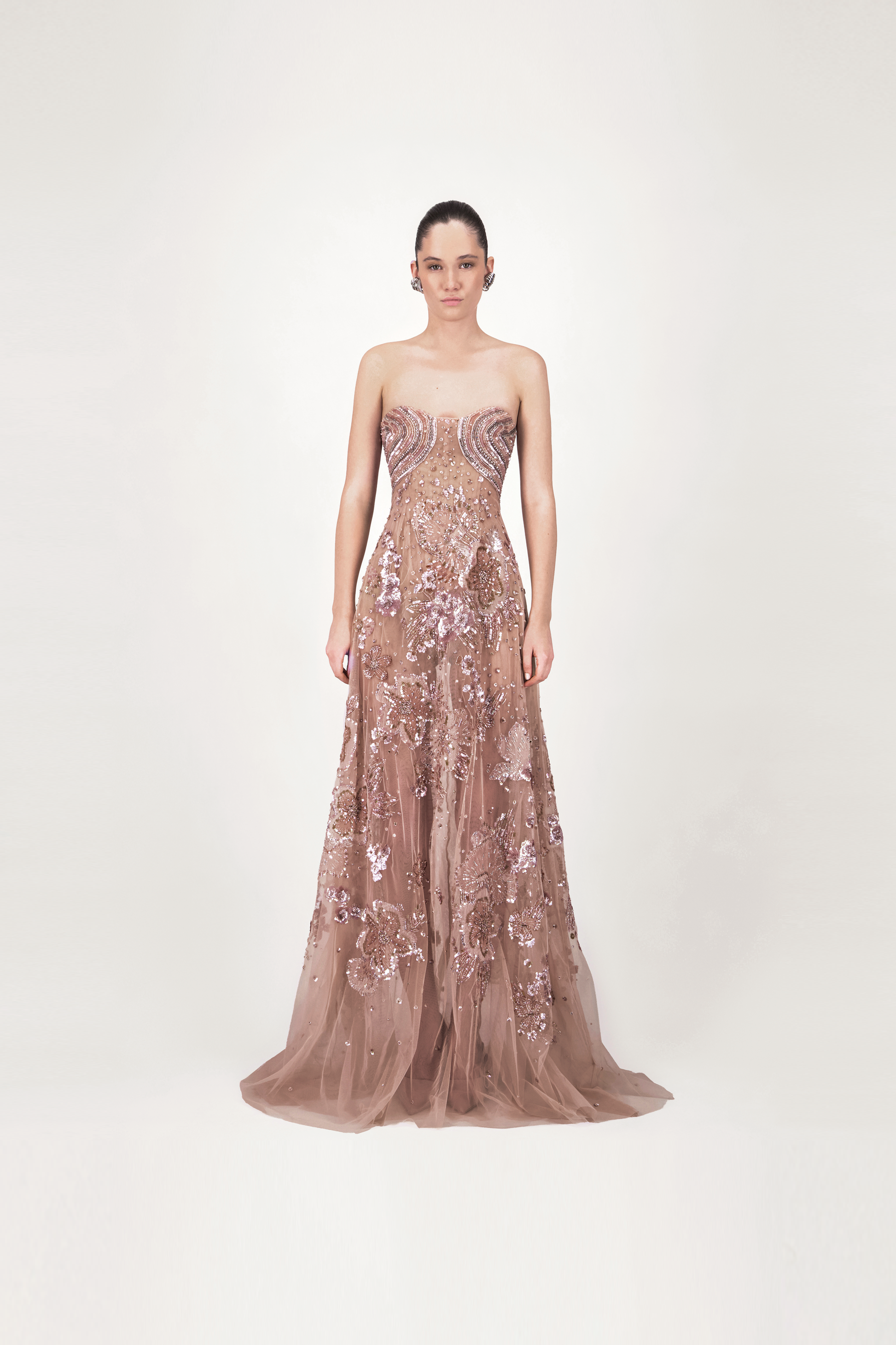 Woman wearing a strapless, sequined evening gown 